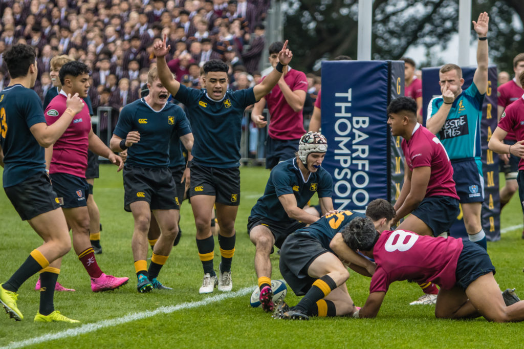 Josh Penney crosses the line for the first try during the annual fixture against King's College